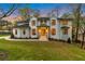 Beautiful two-story home featuring a painted brick facade, black trim, and lush green lawn at twilight at 3968 Ashford Dunwoody, Brookhaven, GA 30319