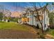 Charming exterior featuring a well-manicured lawn and inviting front porch with black framed windows at dusk at 3968 Ashford Dunwoody, Brookhaven, GA 30319