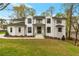 Beautiful home exterior featuring a well-manicured lawn and inviting front porch with black framed windows at 3968 Ashford Dunwoody, Brookhaven, GA 30319