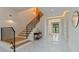 Bright foyer with hardwood stairs, black iron railing, and marble tile flooring at 3968 Ashford Dunwoody, Brookhaven, GA 30319