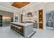 Stylish kitchen with a textured wood ceiling, pendant lighting, and a large island with seating at 3968 Ashford Dunwoody, Brookhaven, GA 30319