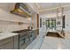 Modern kitchen featuring a center island with brass accents, marble countertops, and stainless steel appliances at 3968 Ashford Dunwoody, Brookhaven, GA 30319