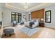 Spacious main bedroom with wood accent wall, tray ceiling and sitting area at 3968 Ashford Dunwoody, Brookhaven, GA 30319