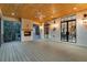 Spacious covered porch featuring a fireplace, ceiling fan, and sleek black-framed doors and windows at 3968 Ashford Dunwoody, Brookhaven, GA 30319