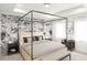 Elegant main bedroom featuring a canopy bed, floral wallpaper, and ample natural light from dual windows at 48 Alameda St # 129, Loganville, GA 30052