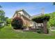 Lush backyard with mature trees, well-maintained lawn, and a brick home exterior at 2039 Fisher Ne Trl, Atlanta, GA 30345