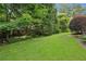 Expansive backyard featuring lush green grass, mature trees, and well-manicured landscaping at 2039 Fisher Ne Trl, Atlanta, GA 30345