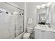 Neutral bathroom featuring shower over tub, black and white tile floor, and stylish vanity with modern fixtures at 2039 Fisher Ne Trl, Atlanta, GA 30345