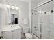 Bright bathroom with modern white vanity, classic black and white tile floor, and shower-over-tub combination at 2039 Fisher Ne Trl, Atlanta, GA 30345