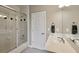 Bathroom featuring shower over tub, neutral tile floor, and vanity with modern fixtures at 2039 Fisher Ne Trl, Atlanta, GA 30345