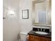 Well-lit bathroom featuring a vanity with dark countertop, stylish mirror, and modern lighting fixture at 2039 Fisher Ne Trl, Atlanta, GA 30345