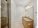 Bathroom featuring a tiled shower, granite countertops, light wood cabinets, and travertine tile floors at 2039 Fisher Ne Trl, Atlanta, GA 30345