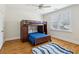 Bedroom featuring a bunk bed, hardwood floors, blue accent rug, and lots of natural light at 2039 Fisher Ne Trl, Atlanta, GA 30345