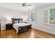 Bedroom with hardwood floors, white walls, a ceiling fan, shuttered windows and a wooden bed frame at 2039 Fisher Ne Trl, Atlanta, GA 30345