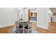 Bright dining room featuring hardwood floors, a square table, and views into kitchen and entryway at 2039 Fisher Ne Trl, Atlanta, GA 30345