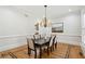 Formal dining room with decorative chandelier, wainscoting, and elegant hardwood floors at 2039 Fisher Ne Trl, Atlanta, GA 30345