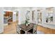 Bright dining room featuring hardwood floors, a square table, and views into the kitchen and patio at 2039 Fisher Ne Trl, Atlanta, GA 30345