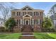 Charming brick home with manicured lawn, black shutters, and brick stairs leading to front door at 2039 Fisher Ne Trl, Atlanta, GA 30345