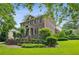 Brick home with a manicured lawn, mature trees, and inviting landscaping at 2039 Fisher Ne Trl, Atlanta, GA 30345