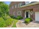Brick home's front entrance with beautiful landscaping, a walkway, and attached garage at 2039 Fisher Ne Trl, Atlanta, GA 30345