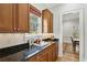 Kitchen bar area with custom wood cabinets, granite countertops, and a view to the dining room at 2039 Fisher Ne Trl, Atlanta, GA 30345