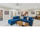 Open-concept living room featuring an elegant blue sectional couch and direct access to the recreation room at 2039 Fisher Ne Trl, Atlanta, GA 30345