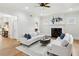 Bright living room with neutral walls, white sofas, wood floors, and access to kitchen area at 2039 Fisher Ne Trl, Atlanta, GA 30345