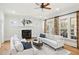 Bright living room with fireplace, hardwood floors, ceiling fan, and stylish decor at 2039 Fisher Ne Trl, Atlanta, GA 30345