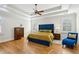 Bright main bedroom with hardwood floors, a blue tufted headboard, and lots of natural light at 2039 Fisher Ne Trl, Atlanta, GA 30345