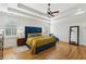 Spacious main bedroom with a blue tufted headboard, tray ceiling, and hardwood floors at 2039 Fisher Ne Trl, Atlanta, GA 30345