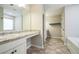 Bright bathroom with a long vanity, soaking tub, stylish tile flooring, and ample counter space at 2534 Grayton Loop, Villa Rica, GA 30180