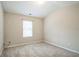 A bright bedroom features neutral walls, plush carpeting and one window at 2534 Grayton Loop, Villa Rica, GA 30180