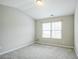 Well-lit bedroom with a window and neutral carpet offers a comfortable space at 2534 Grayton Loop, Villa Rica, GA 30180