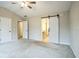 Open bedroom showcasing plush carpet, a sliding barn door, and a ceiling fan, blending modern design and comfort at 2534 Grayton Loop, Villa Rica, GA 30180