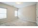 A bright bedroom features neutral walls, plush carpeting and two windows at 2534 Grayton Loop, Villa Rica, GA 30180