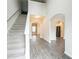 Bright foyer with staircase and hardwood flooring leads to the kitchen and other areas of the home at 2534 Grayton Loop, Villa Rica, GA 30180