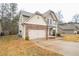 Charming two-story home featuring a well-manicured lawn, stone accents, and an attached two-car garage at 2534 Grayton Loop, Villa Rica, GA 30180