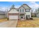 Charming two-story home featuring a well-manicured lawn, stone accents, and an attached two-car garage at 2534 Grayton Loop, Villa Rica, GA 30180