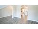 Hallway leading to kitchen with hardwood flooring, creating a seamless flow and modern aesthetic at 2534 Grayton Loop, Villa Rica, GA 30180