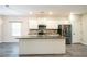 Modern kitchen with white cabinetry, stainless steel appliances, granite countertops and center island at 2534 Grayton Loop, Villa Rica, GA 30180