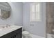 Bathroom featuring a granite vanity top, brushed nickel fixtures, and a framed round mirror at 4325 Bellview Ln, Duluth, GA 30097