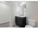 Bathroom with dark wood vanity, marble countertop, and large mirror with vanity lighting at 4325 Bellview Ln, Duluth, GA 30097