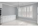 Dining area with a chandelier, white cabinets, and shuttered windows, offering bright, airy space at 4325 Bellview Ln, Duluth, GA 30097