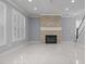 Open living space with a stone fireplace, and staircase, illuminated by plantation shutters at 4325 Bellview Ln, Duluth, GA 30097