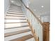 Stairway with wood treads and white risers leads to the upper level of the home at 4325 Bellview Ln, Duluth, GA 30097