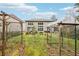 Large, enclosed backyard with garden boxes, mature trees, and ample space for outdoor activities at 5225 Tye Trl, Fairburn, GA 30213