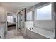 Bright bathroom with glass shower, tub, and neutral-tone tile at 64 Roberson Ne Dr, Cartersville, GA 30121