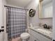 Well-lit bathroom featuring a granite countertop, modern sink faucet, decorative mirror, and a shower with curtain at 64 Roberson Ne Dr, Cartersville, GA 30121