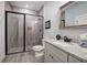 Modern bathroom featuring a glass-enclosed shower, granite countertop, and gray tiles on the walls and floors at 64 Roberson Ne Dr, Cartersville, GA 30121