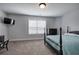 Bright bedroom featuring carpet, bed, ceiling fan, and dresser, offering a cozy and inviting space at 64 Roberson Ne Dr, Cartersville, GA 30121